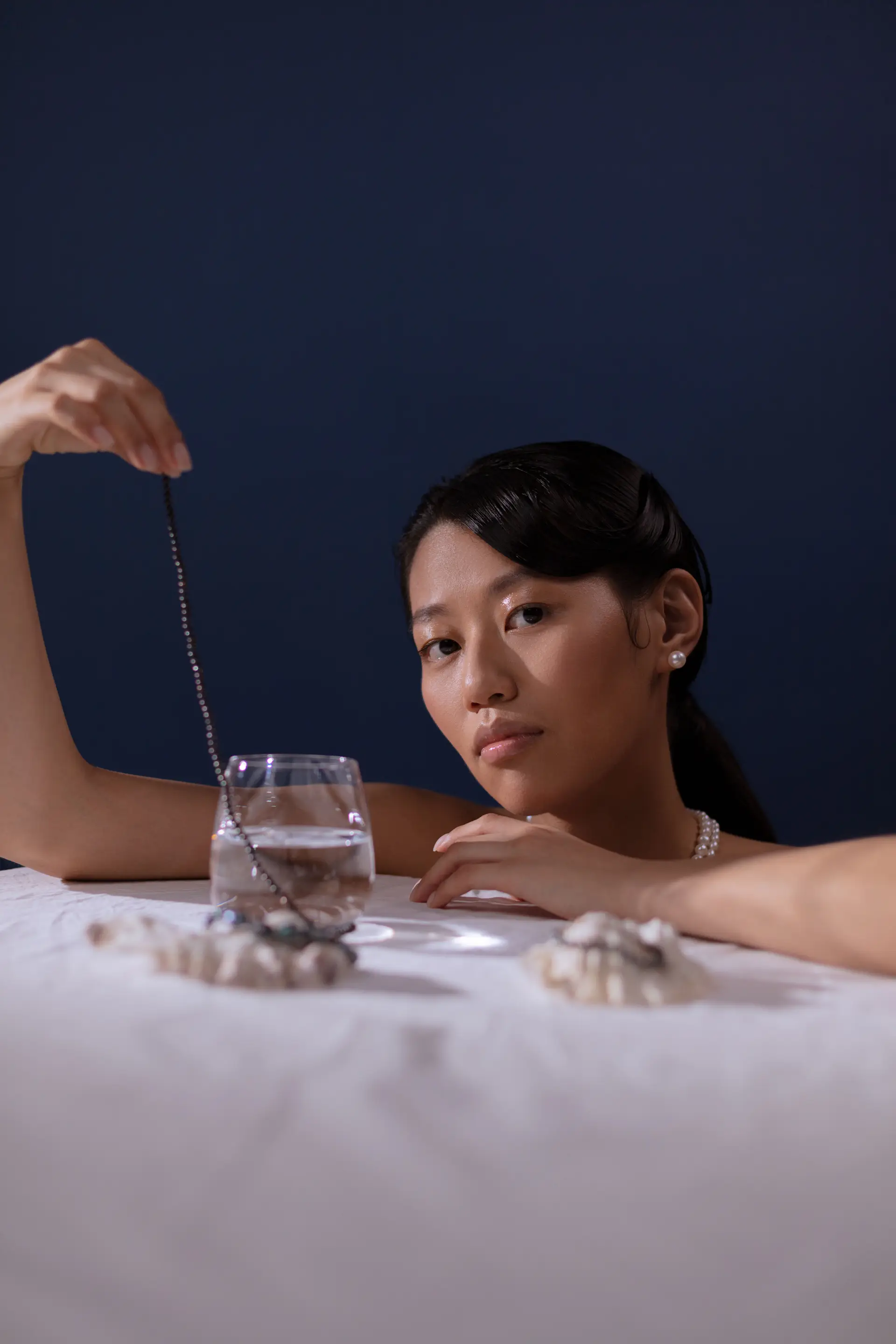 Elegant pearl jewelry reflecting in water